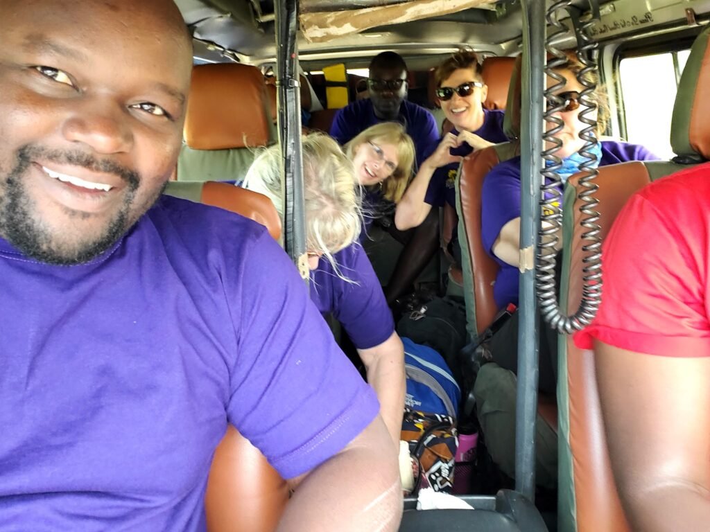 Travelers riding together in an open safari vehicle